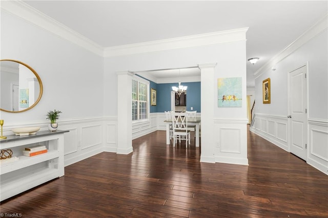 301 Summerwalk Rd, Greensboro, NC 27455 - dining area with a chandelier, hardwood / wood-style flooring, crown molding, a wainscoted wall, and a decorative wall