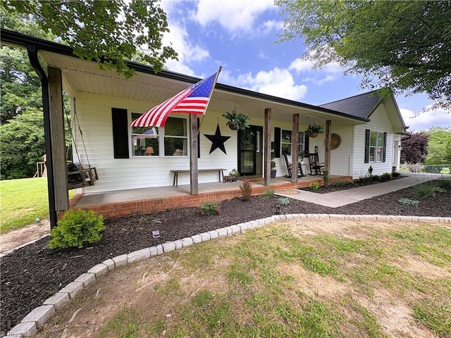 132 Mulberry Ln, Stokesdale, NC 27357 - view of front facade featuring a porch and a front lawn