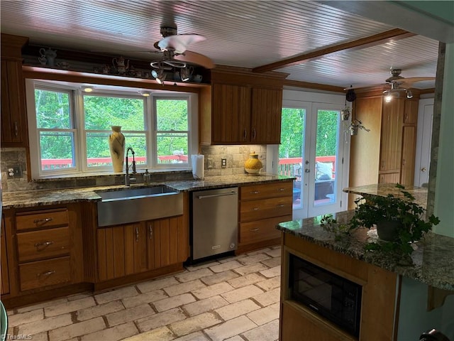 kitchen with a sink, stainless steel dishwasher, black microwave, and tasteful backsplash