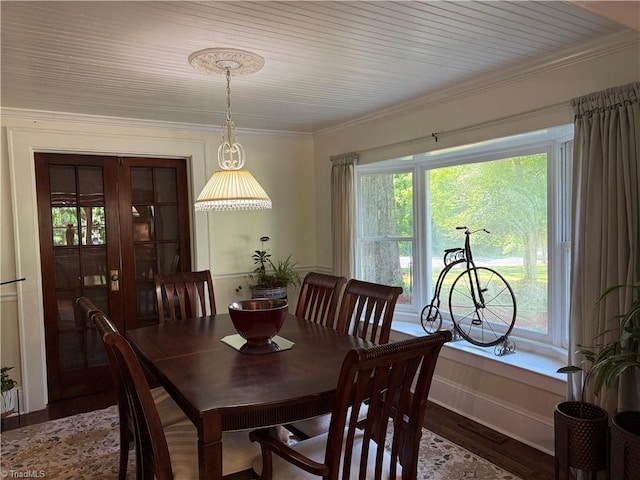 dining area featuring wood finished floors and ornamental molding