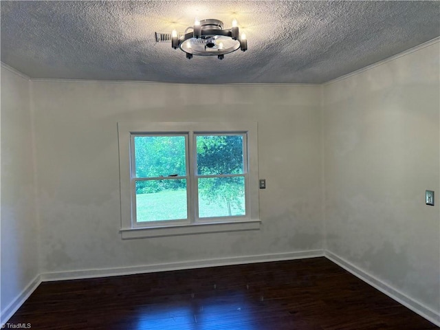 unfurnished room featuring wood finished floors, a textured ceiling, baseboards, and crown molding