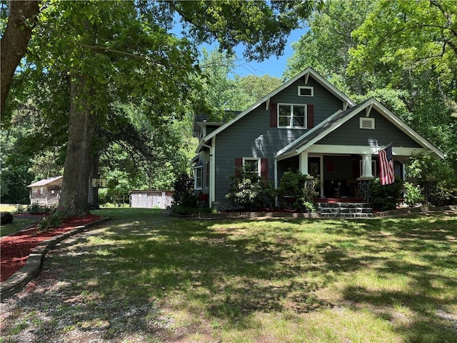 view of front of home featuring covered porch and a front lawn