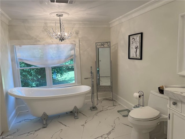 bathroom featuring marble look tile flooring, toilet, a freestanding bath, ornamental molding, and a chandelier