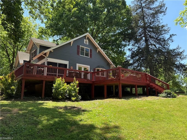 rear view of property with a wooden deck and a yard