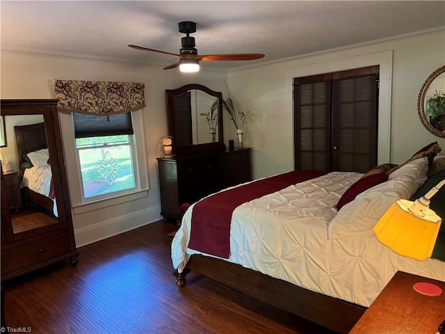 bedroom featuring ornamental molding, wood finished floors, baseboards, and a ceiling fan