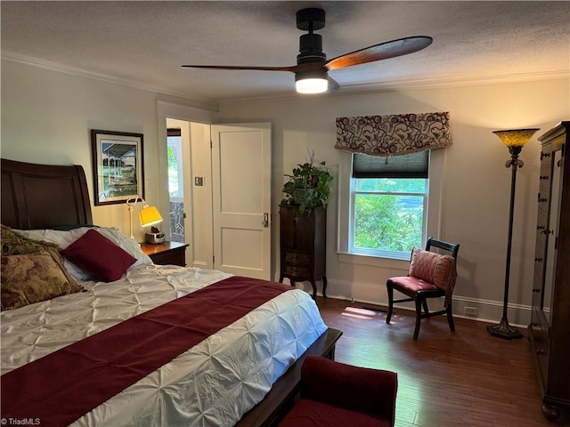 bedroom with ornamental molding, a textured ceiling, dark wood-style floors, baseboards, and a ceiling fan