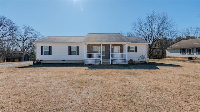 ranch-style home featuring covered porch and a front lawn