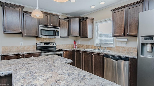 kitchen with dark brown cabinetry, appliances with stainless steel finishes, and sink