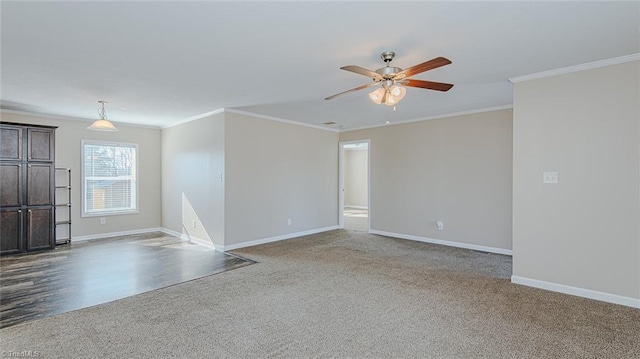 empty room featuring crown molding, carpet, and ceiling fan