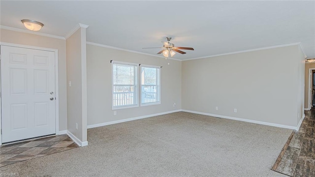 foyer entrance with dark carpet, crown molding, and ceiling fan