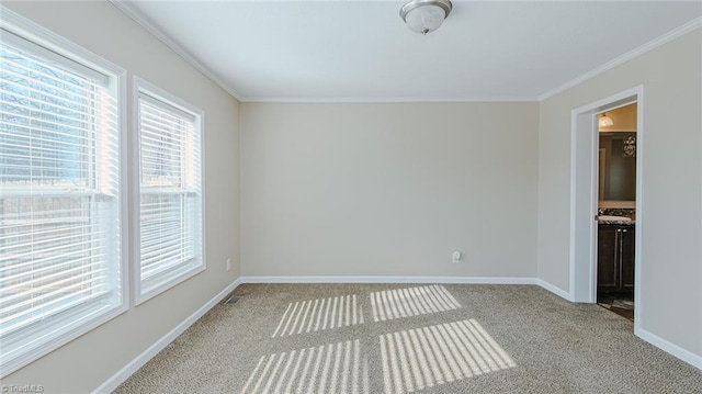 carpeted spare room with ornamental molding