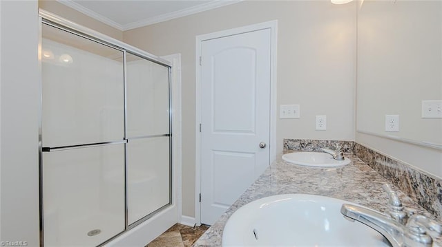 bathroom with ornamental molding, a shower with shower door, and vanity