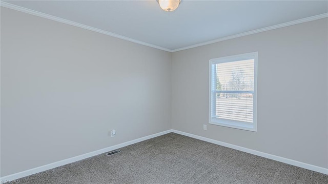 carpeted empty room featuring crown molding