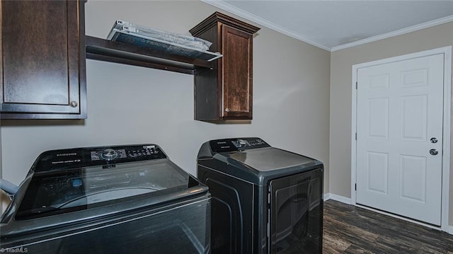 laundry area with cabinets, ornamental molding, dark hardwood / wood-style flooring, and washer and dryer