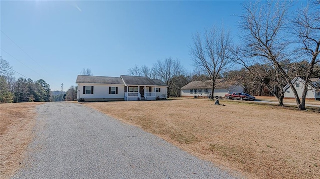 ranch-style house with covered porch and a front yard