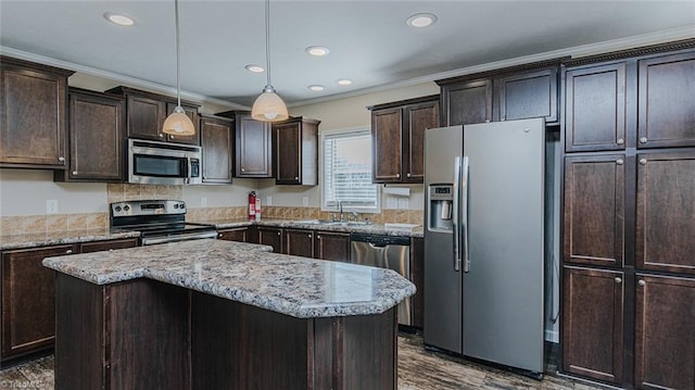 kitchen featuring dark brown cabinetry, appliances with stainless steel finishes, and a kitchen island