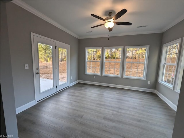 interior space with ceiling fan, hardwood / wood-style floors, and crown molding