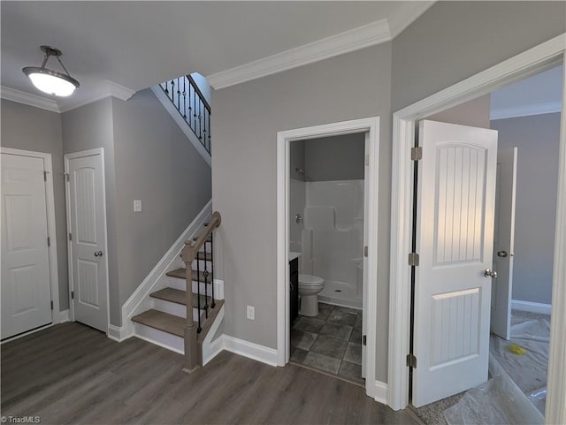 stairs featuring crown molding and hardwood / wood-style flooring