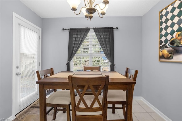 dining room featuring a notable chandelier and light tile patterned flooring