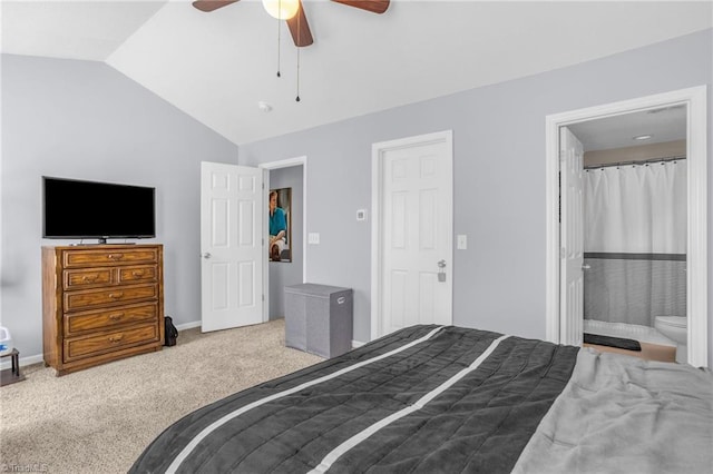 bedroom featuring ensuite bath, ceiling fan, carpet floors, and vaulted ceiling