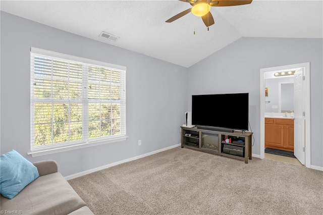 carpeted living room featuring vaulted ceiling, ceiling fan, and sink