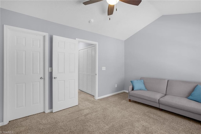 living room with light colored carpet, ceiling fan, and lofted ceiling