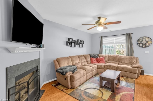 living room featuring ceiling fan and hardwood / wood-style flooring