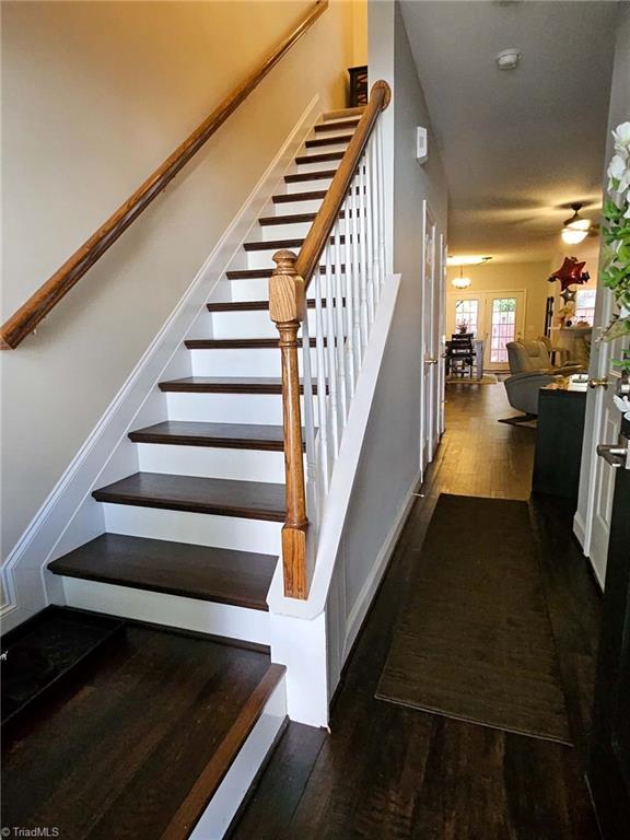 stairs with hardwood / wood-style flooring