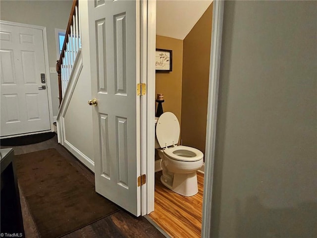 bathroom with toilet and wood-type flooring