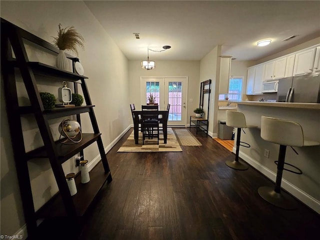 dining area featuring dark wood-type flooring and french doors