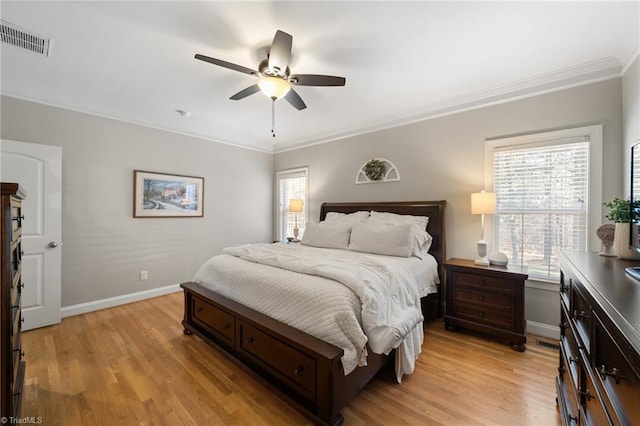 bedroom featuring visible vents, multiple windows, and light wood-style floors