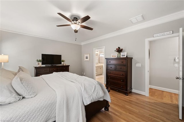 bedroom with a ceiling fan, connected bathroom, light wood-style floors, crown molding, and baseboards