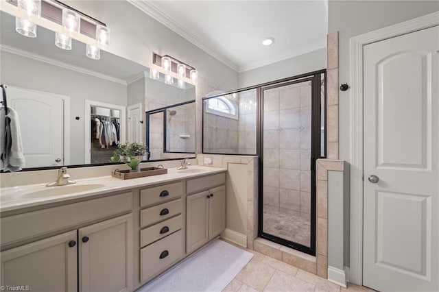 full bath with a sink, a stall shower, ornamental molding, and double vanity