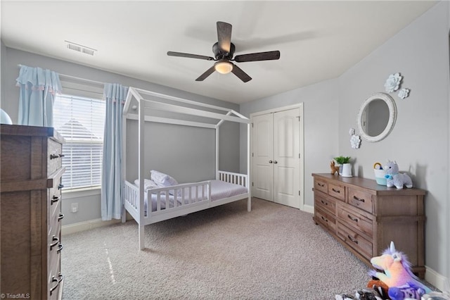 bedroom featuring visible vents, baseboards, carpet, and a closet