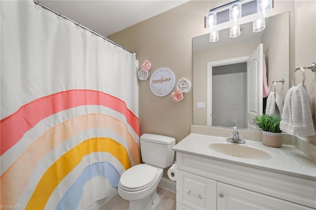 bathroom featuring toilet, vanity, and a shower with curtain