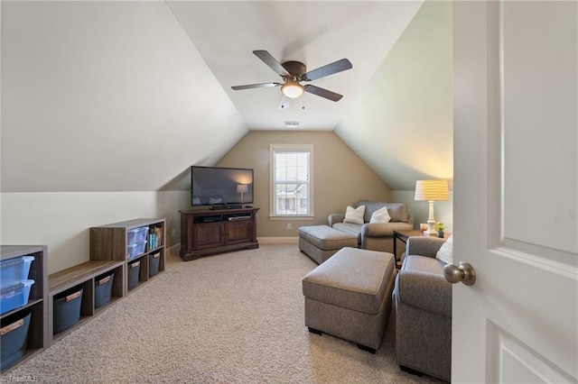 living area featuring vaulted ceiling, a ceiling fan, baseboards, and carpet floors