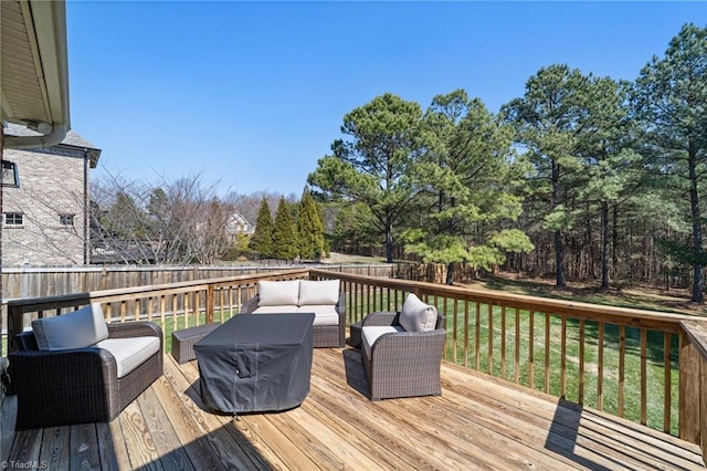 deck featuring an outdoor living space and a fenced backyard