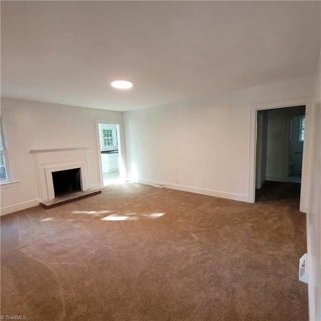 unfurnished living room featuring carpet