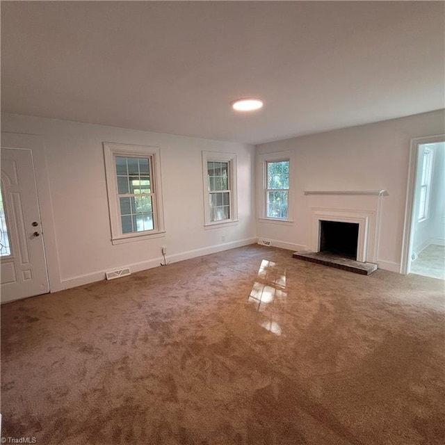 unfurnished living room featuring carpet floors