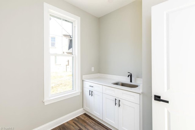 112 Emerald Ct, Trinity, NC 27370 - laundry area with a sink, healthy amount of natural light, baseboards, and dark wood-type flooring
