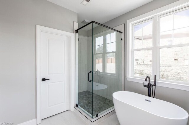 112 Emerald Ct, Trinity, NC 27370 - full bathroom with a freestanding bath, a shower stall, and tile patterned flooring