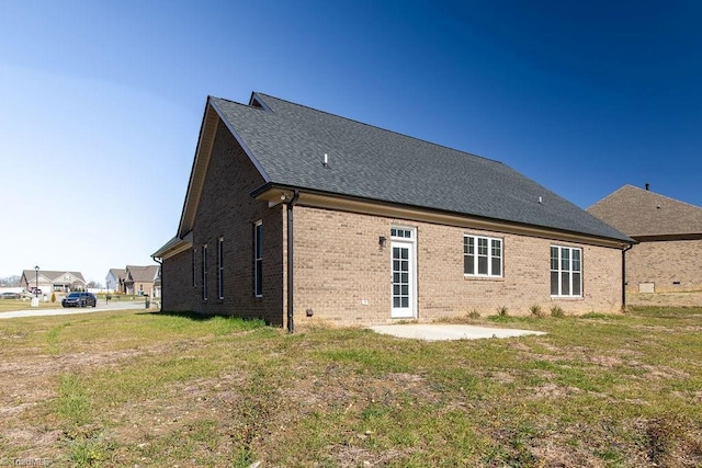 112 Emerald Ct, Trinity, NC 27370 - rear view of property featuring a patio, brick siding, a yard, and roof with shingles
