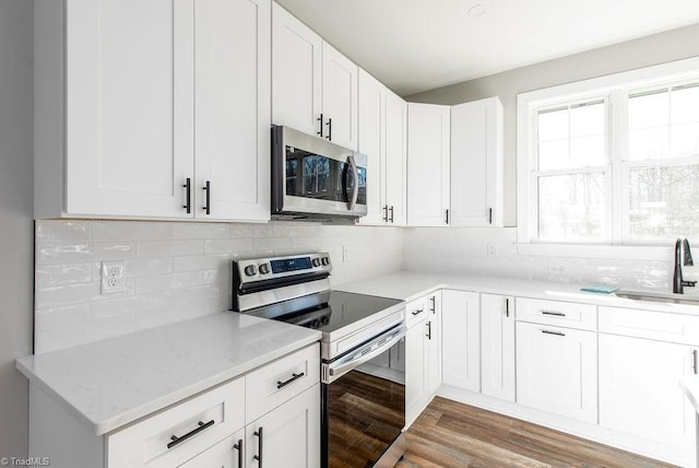 112 Emerald Ct, Trinity, NC 27370 - kitchen featuring appliances with stainless steel finishes, a sink, light stone countertops, and white cabinets