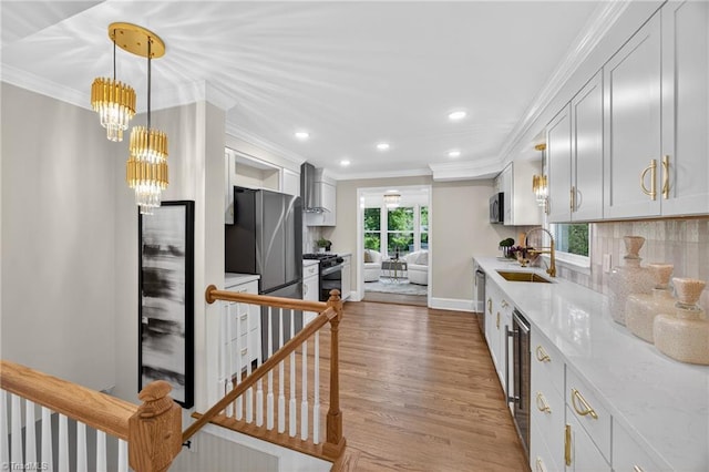 506 Audubon Dr, Greensboro, NC 27410 - kitchen with ornamental molding, recessed lighting, wood finished floors, stainless steel appliances, and light stone countertops