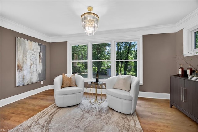 506 Audubon Dr, Greensboro, NC 27410 - sitting room featuring light wood finished floors, crown molding, and a chandelier
