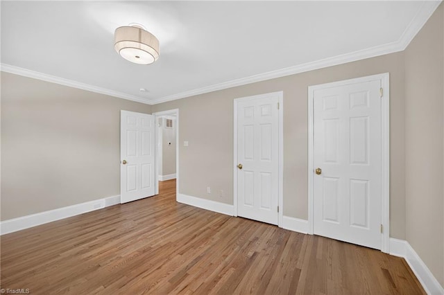 506 Audubon Dr, Greensboro, NC 27410 - unfurnished bedroom featuring wood finished floors and crown molding