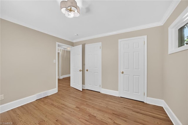 506 Audubon Dr, Greensboro, NC 27410 - unfurnished bedroom featuring light wood-style floors and ornamental molding
