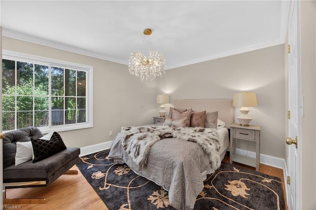 506 Audubon Dr, Greensboro, NC 27410 - bedroom with ornamental molding, a chandelier, and wood finished floors