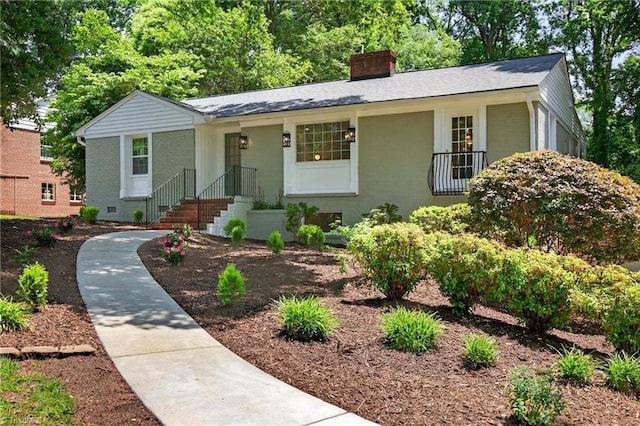 506 Audubon Dr, Greensboro, NC 27410 - view of front of home with a chimney, brick siding, and roof with shingles