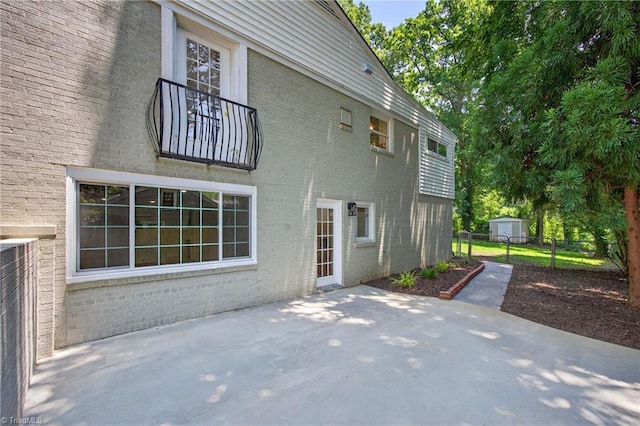 506 Audubon Dr, Greensboro, NC 27410 - rear view of property with brick siding and a patio area